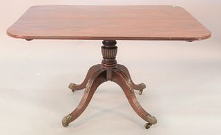 Georgian mahogany breakfast tip table having single board top on pedestal ending in brass capped feet, c.1820, ht. 28 1/2", top 42" x 49".