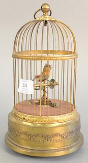 Singing bird in brass cage, in working condition, ht. 11".