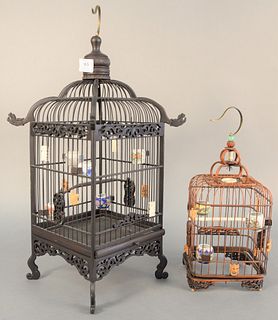 Two Chinese bird cages having porcelain water and food bowls on interior, hts. 14 1/2" and 22". Estate of Marilyn Ware, Strasburg, PA.