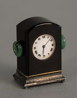 Miniature clock having case with jade ring handles, white enameled face on silver base, ht. 2".