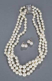Three strand pearl necklace with diamond clasp.