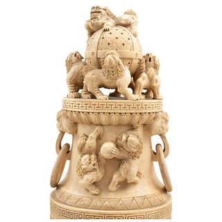 Urn. China, Ca .1900. Carved and inked ivory decorated with Foo dog figures, dragons on the handles and floral motifs.