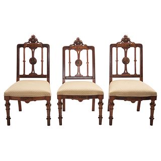 Lot of three chairs, 20th century, Carved wood with floral motifs and decorative details on backs.
