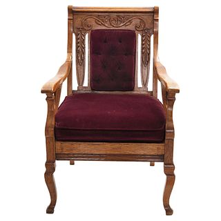 Armchair, Early 20th century, Carved wood decorated with plant motifs and wine-colored upholstery.