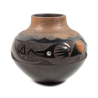 Russell Sanchez
(San Ildefonso, b. 1963)
Micaceous Black and Sienna Jar, with Avanyu, 1981 Lot is located and will ship from Denver, Colorado.