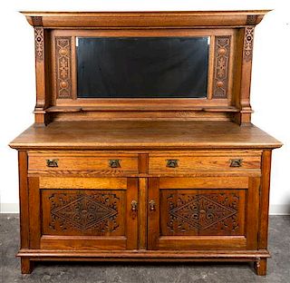 * An English Arts and Crafts Oak Sideboard, Robson and Sons, Ltd., Newcastle Height 74 1/4 x width 71 1/2 x depth 24 3/4 inches.
