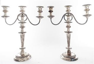 A Pair of Silver-plate Three-Light Candelabra, , each having a baluster form standard with scrolling candle arms and raised on a
