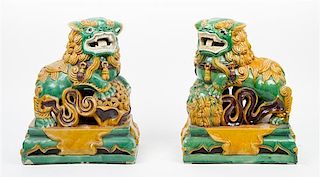 * A Pair of Sancai Pottery Fu Lions Height 15 1/4 x width 12 1/4 inches.