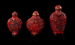 A Group of Three Cinnabar Lacquer Snuff Bottles Height of tallest 3 1/8 inches.