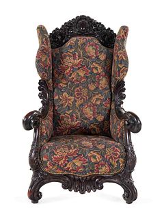 A Karpen Carved Mahogany Wingback Armchair