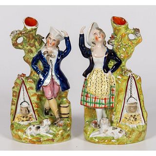 A Pair of Staffordshire Male and Female Figural Spill Vases