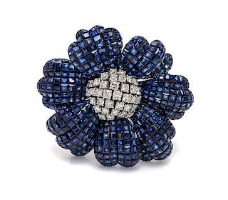An 18 Karat White Gold, Invisibly Set Sapphire and Diamond Flower Brooch, 35.00 dwts.
