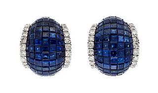A Pair of 18 Karat White Gold and Invisibly Set Sapphire and Diamond Earclips, 14.90 dwts.