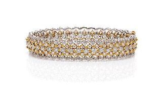 An 18 Karat Two Tone Gold and Diamond Bangle Bracelet, 17.30 dwts.