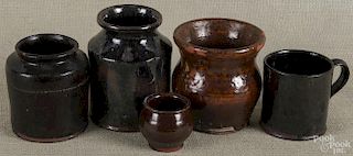 Five pieces of assorted Pennsylvania redware, 19th/20th c., to include a vase, two jars