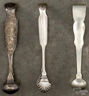 Three American coin silver sugar tongs, 19th c., bearing the touches of R & W Wilson, W. Eden