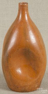 Orange and green glazed pottery pinch bottle, likely North Carolina, unsigned, 9 3/4'' h.