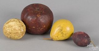 Painted redware apple bank, late 19th c., together with three pieces of composition fruit.