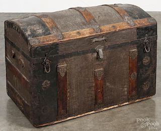 Dome lid trunk, late 19th c., having a fitted interior with lithograph compartments, 20'' h.