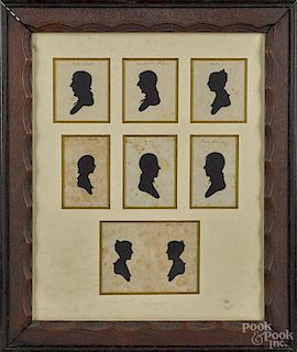 Set of seven hollowcut silhouettes of a family, 19th c., all mounted in a period carved frame