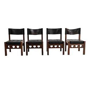 Lote de 4 sillas. México. SXX. Don S. Shoemaker. En talla de madera tropical. Con respaldos y asientos capitonados de piel color negro.