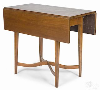 New England Federal cherry Pembroke table, early 19th c., with a serpentine stretcher, 29'' h.