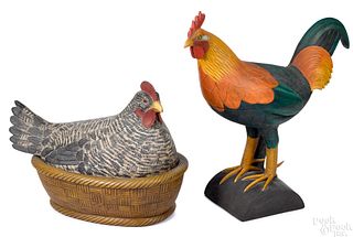 Two carved figures of a rooster and hen on nest