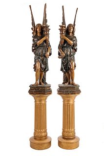 A Pair of Continental Carved and Painted Figural Prickets with Associated Pedestals