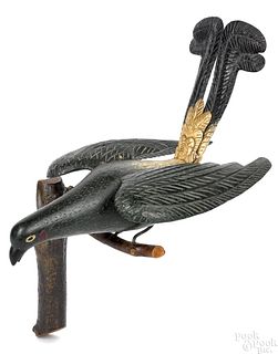 Carved and painted plumed bird on perch