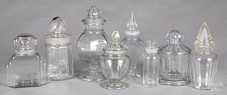 Eight colorless glass candy or apothecary bottles