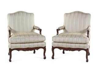 A Pair of Louis XV Style Carved Walnut Fauteuils