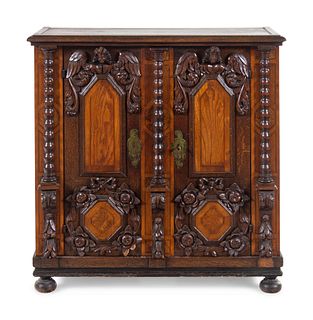 An Italian Baroque Carved Walnut and Oak Cabinet