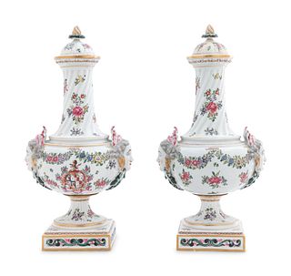 A Pair of Continental Painted and Parcel Gilt Porcelain Urns