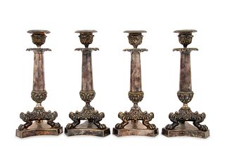 A Set of Four Neoclassical Silvered Bronze Candlesticks