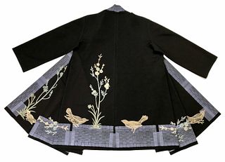 Black coat with small blossom tree, birds and a blue border.