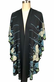 Black, turquoise and pale green ruana with leaves and butterflies.