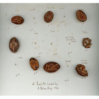 A Group Of Ahnd Carved Peach Pit Buttons