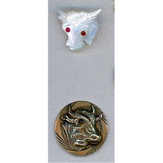 A Pair Of Assorted Material Glass Eyed Cow Buttons