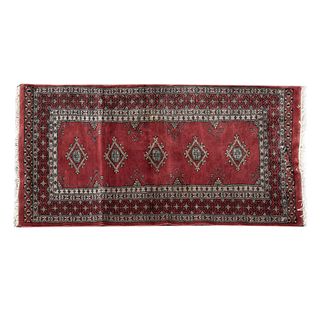 Tapete de oración. Siglo XX. Estilo Boukhara. En fibras de lana y algodón. Decorados sobre fondo vino y gris. 78 x 146 cm