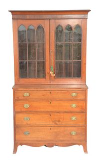 Federal Cherry two part cabinet/chest, upper section with two glazed doors on lower section having four drawers all set on French fe...