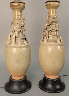 Pair of Chinese Funerary Vases with molded figures and dragons. vase height 16 1/2 inches, total height 30 1/2 inches. Provenance: A...