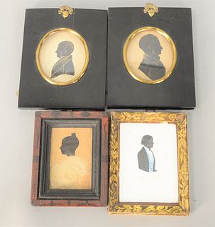 Group of Four Silhouettes to include two busts of a man with highlights; one of a woman with lock of hair in grain painted frame alo...