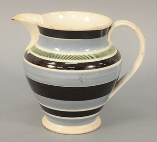Mocha Jug having engine turnings with line and slip banding (handle has crack).
height 6 3/4 inches.
Provenance: Estate of Michael C...