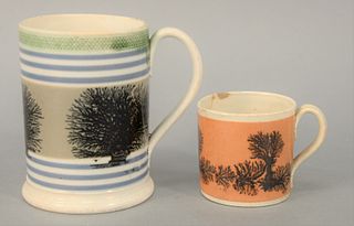 Two Mocha Mugs, one with engine turning band over banding and trees, the smaller with trees and granite background.
heights 2 1/2 in...