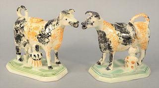 Pair of Pearlware Cow Creamers with milkers spatterware decorated (one cover repaired), green glazed base.
height 5 1/2 inches. 
Est...
