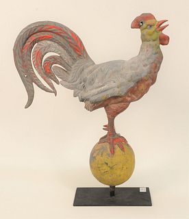 Full Bodied Rooster Weathervane standing on a ball, remnants of red and yellow paint, on a stand, (legs with old repair near feet).
...