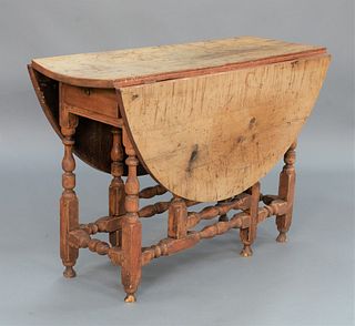 Gateleg Drop Leaf Table with long drawer, maple with tiger maple top, traces of old red paint, New England, circa 1700.
height 27 1/...