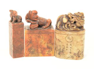 Three Soapstone Carved Seals, each with animals on top and carved designs, two are signed.
heights 3, 3 1/4, 3 1/4 inches.