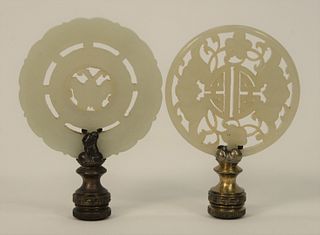 Two Jade Discs made into Lamp Finials, one having double surround with central movable mount (white - light green), and one having r...