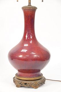 Chinese Sang de Boeuf Vase, having dark red with purple glaze on bronze stand with bronze top made into a table lamp.
total height 2...